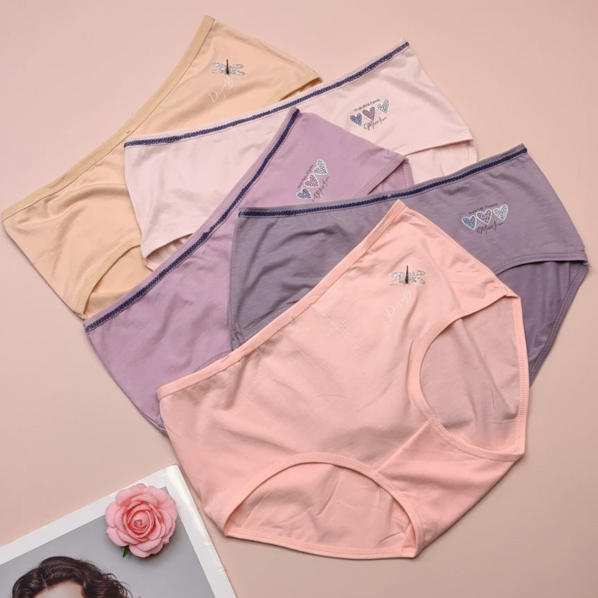 Set of women's underwear in various colors on a beige background