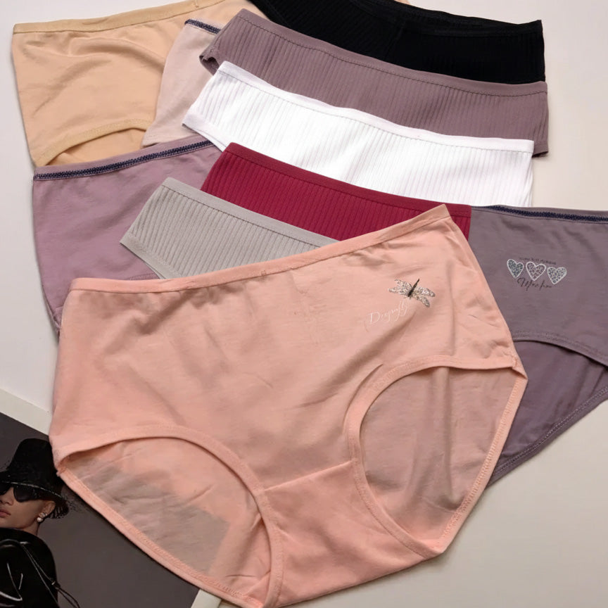 Various pairs of women's underwear in different colors and designs on a light background.