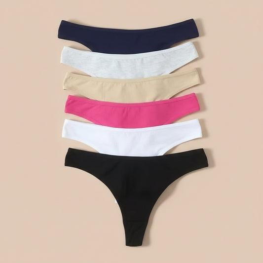 Set of five pairs of underwear in black, white, pink, beige, and navy on a beige background.
