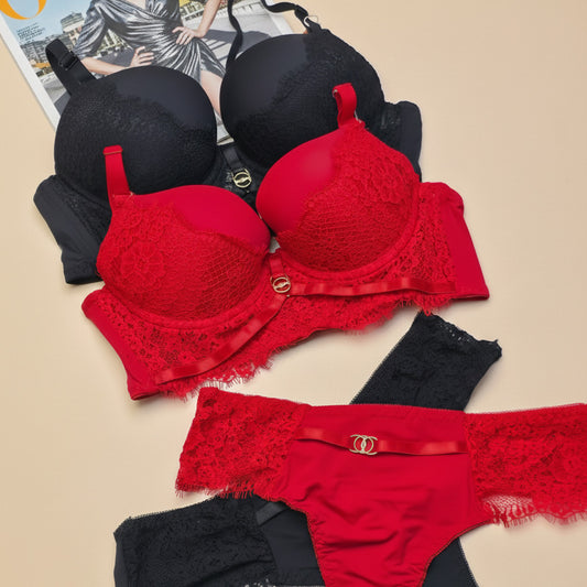 Red and black lace lingerie set on a beige surface